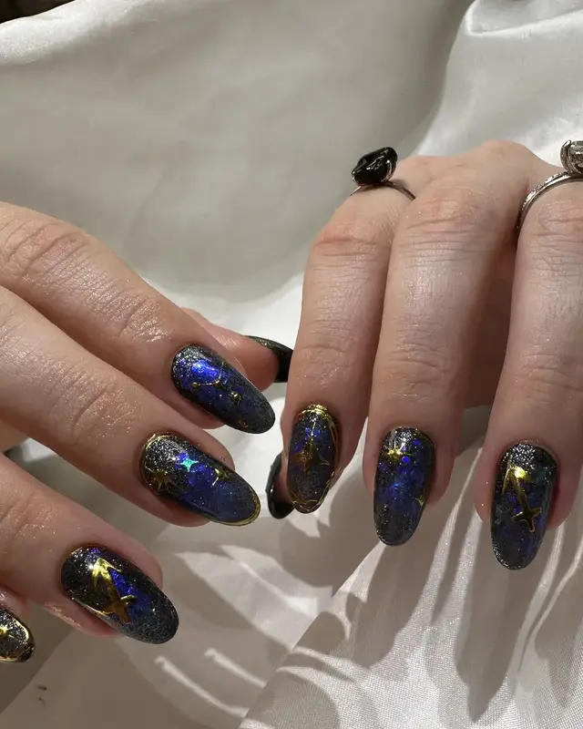 Midnight blue manicure with gold sparkle