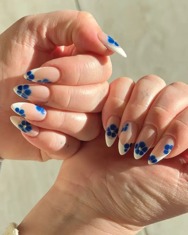 Blue floral nail art in natural light