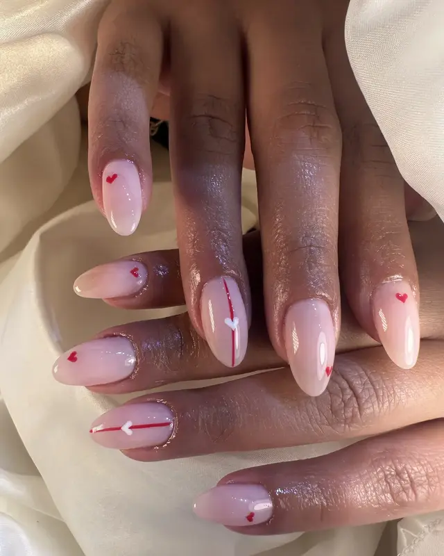 Glossy pale pink manicure with tiny heart details