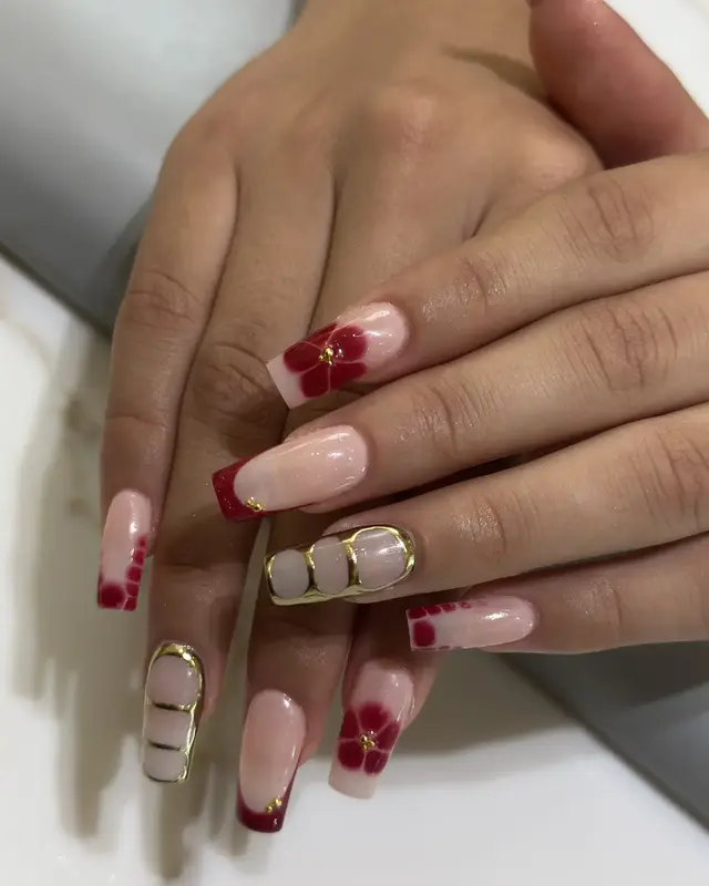 Burgundy French manicure with gold embellishment